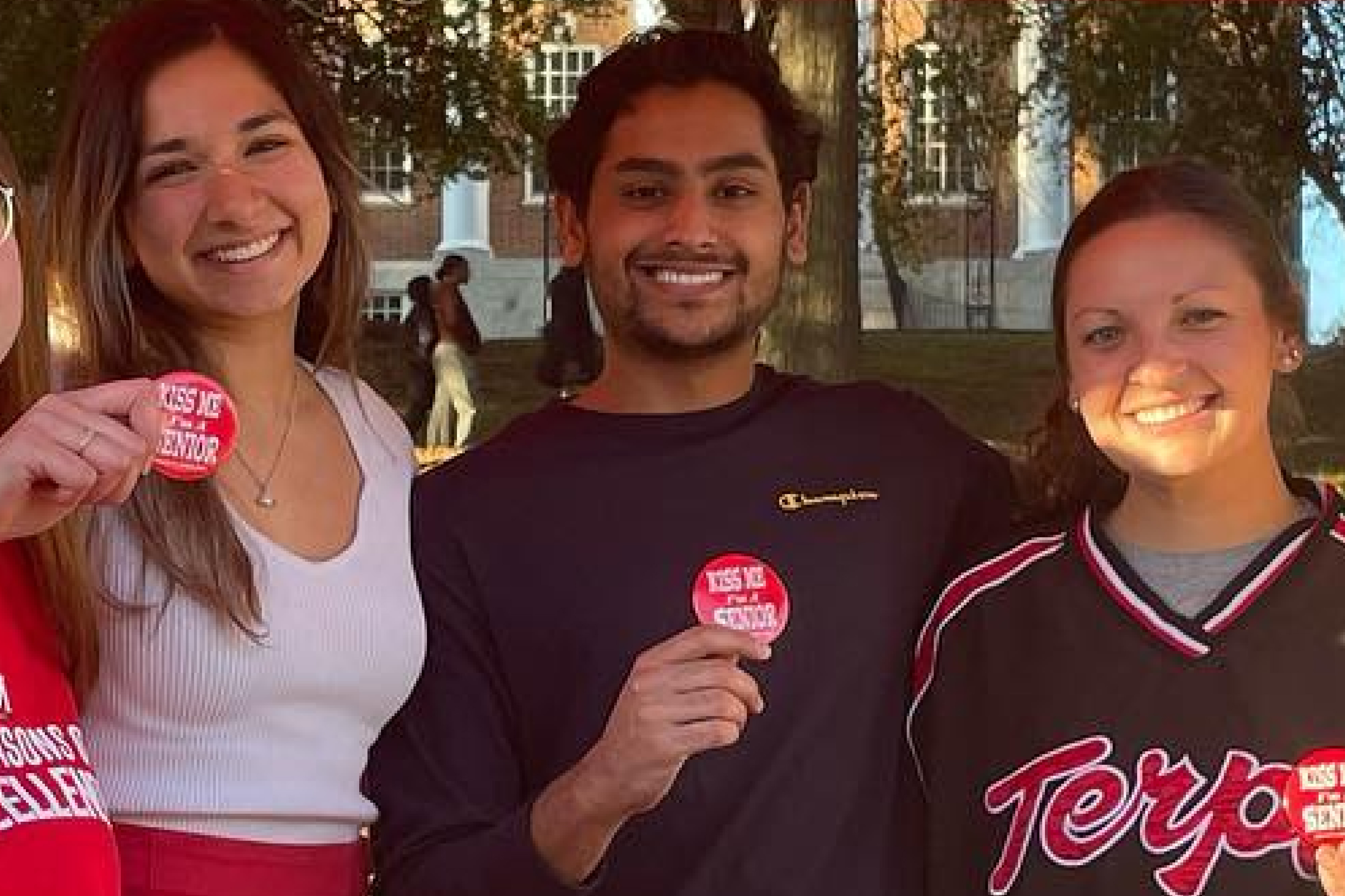 students showing their senior pins