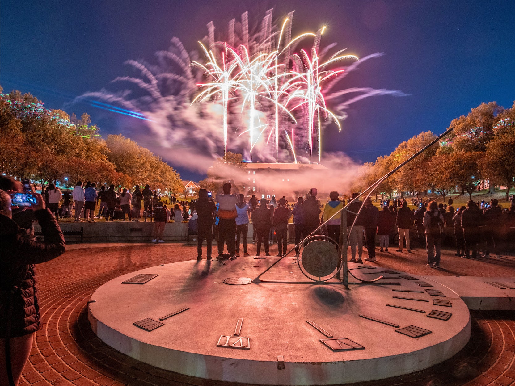 UMD community members watch fireworks ignite above McKeldin Library.
