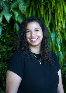 Photo of Hana Zewdie in a black shirt with a plant backdrop