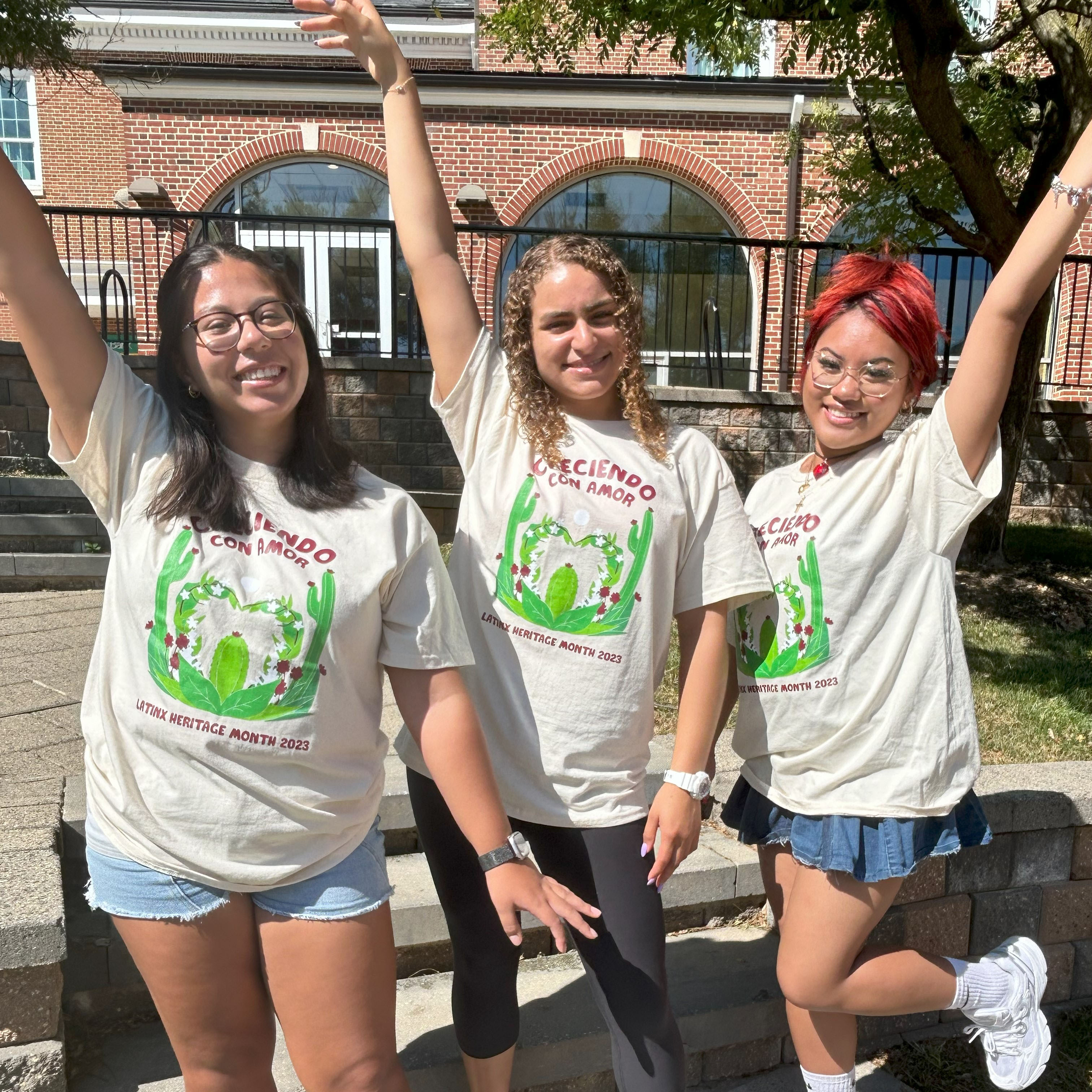 three students with arm raised