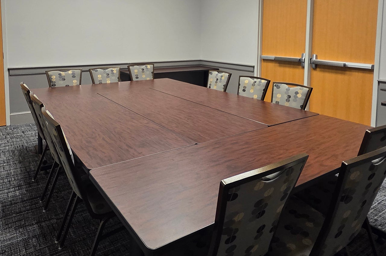 Edgar Allen Poe Room with a wooden table and 12 chairs.