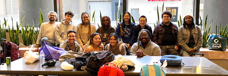 A group of students is smiling at the camera