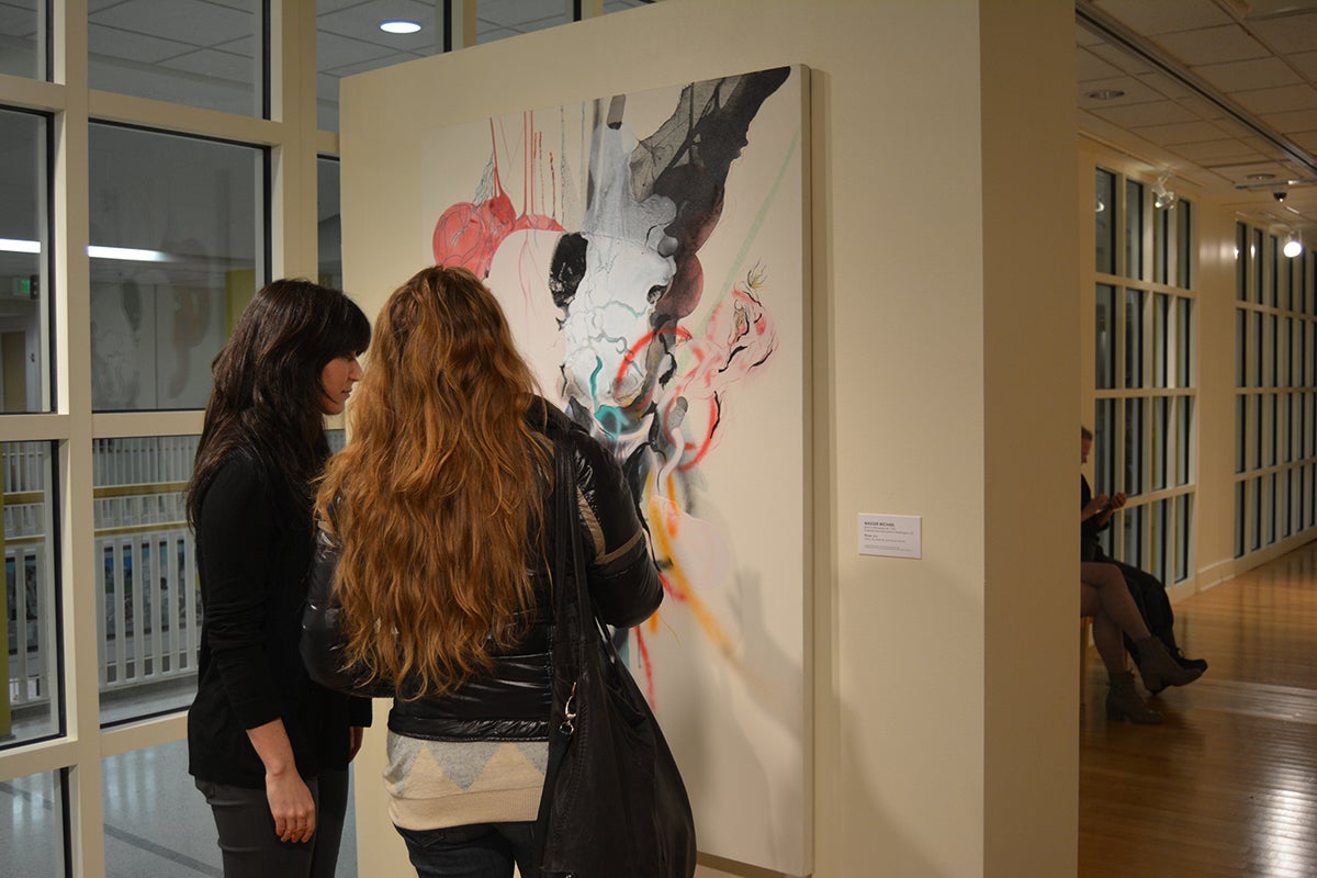 Lindsay Smilow and the artist Maggie Michael examine Michael's painting Throw (2006), acquired by the 2006-07 CAPP committee. Photo: Christopher Bugtong.