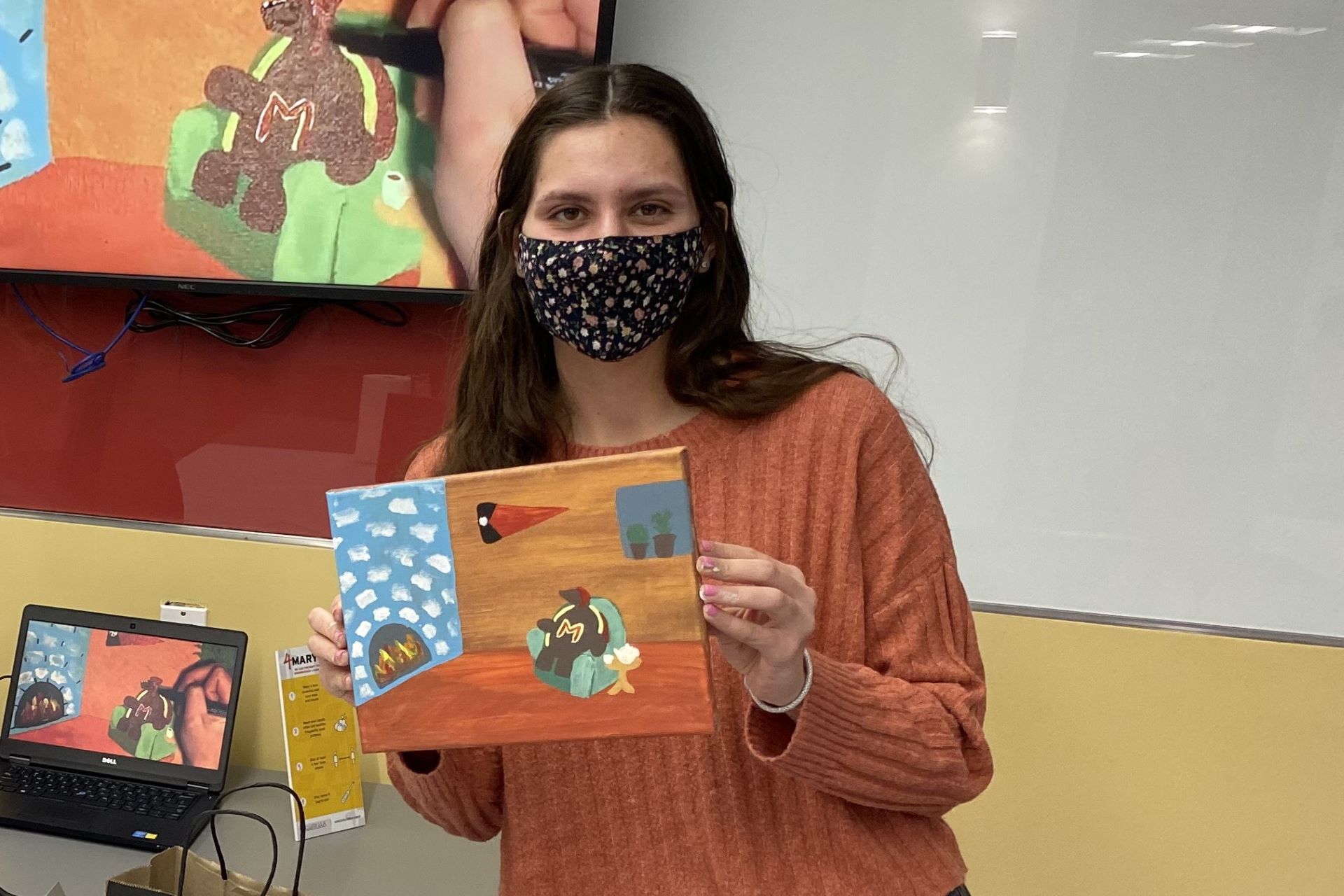 person holding a painting