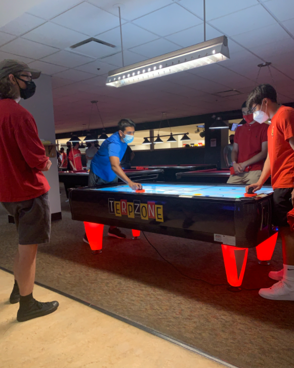 Students playing at an air hockey table in Terpzone