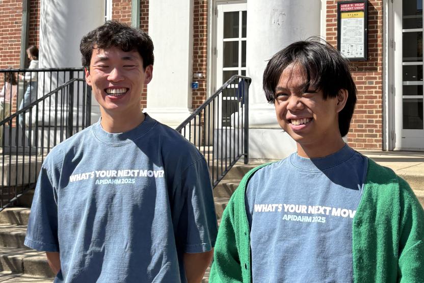two students standing outside Stamp