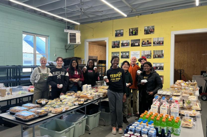 AB team poses in front of the food they are about to pack up into care packages for the community of Wytheville, VA. 