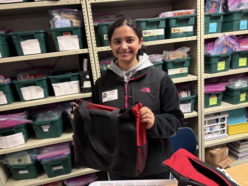 Reading mentor holding supplies