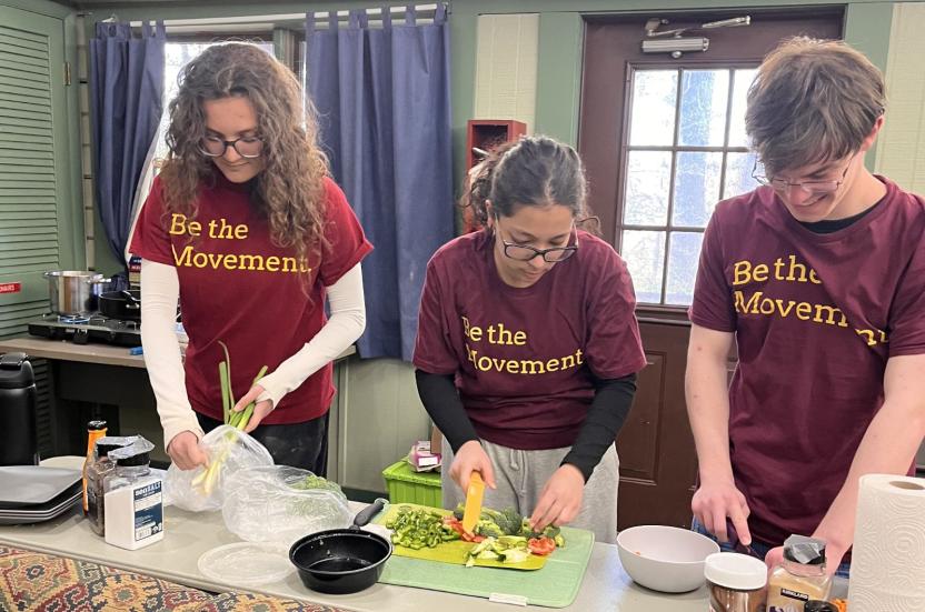 AB team members cook dinner together