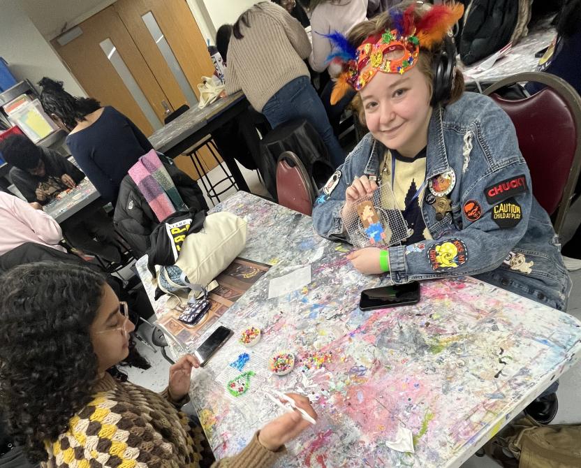 Two students craft at a table
