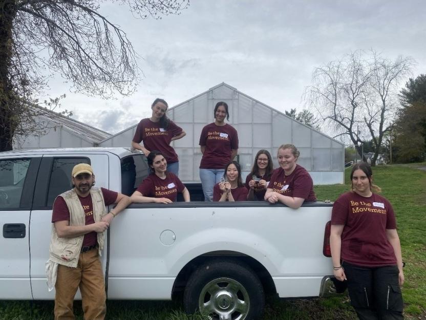 AB team posing in front of a pickup truck