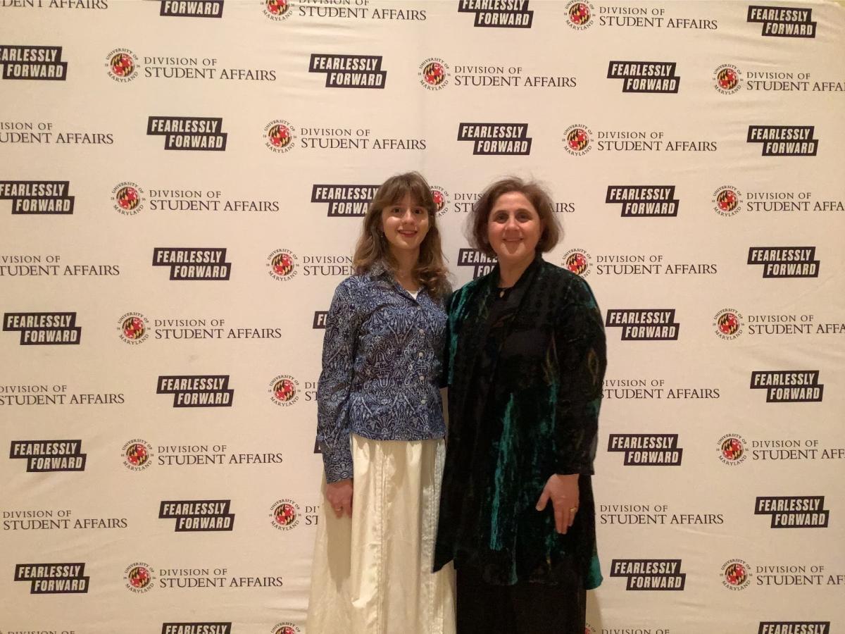 A photobooth photo of an award recipient and her guest