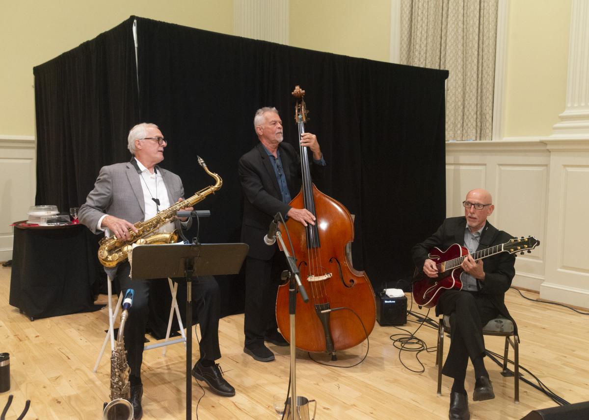 Image of the 3 member band playing a song