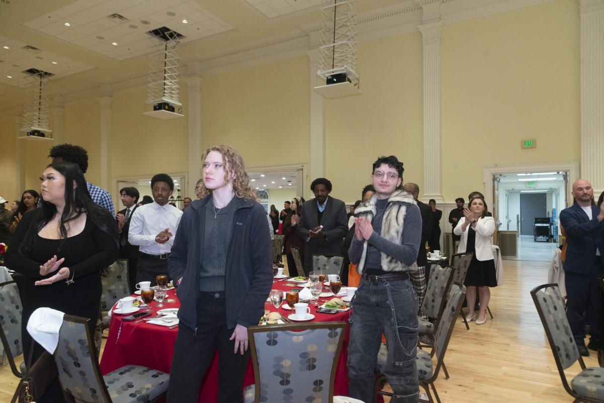 Photo of atendees standing for the UMD alma mater