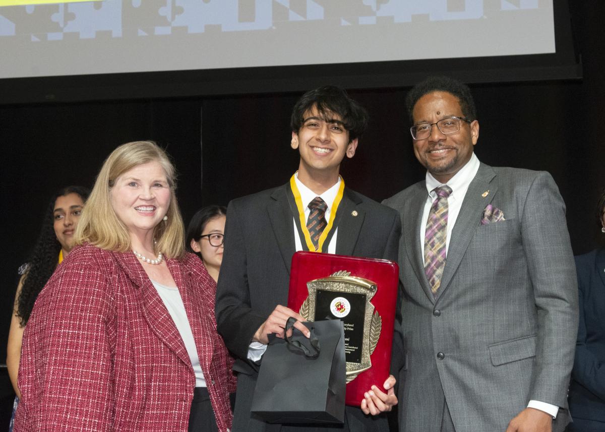 A photo of Dr. Patty Perill, the Model citizenship prize recipient, Dhruvak Mirani, and President Pines
