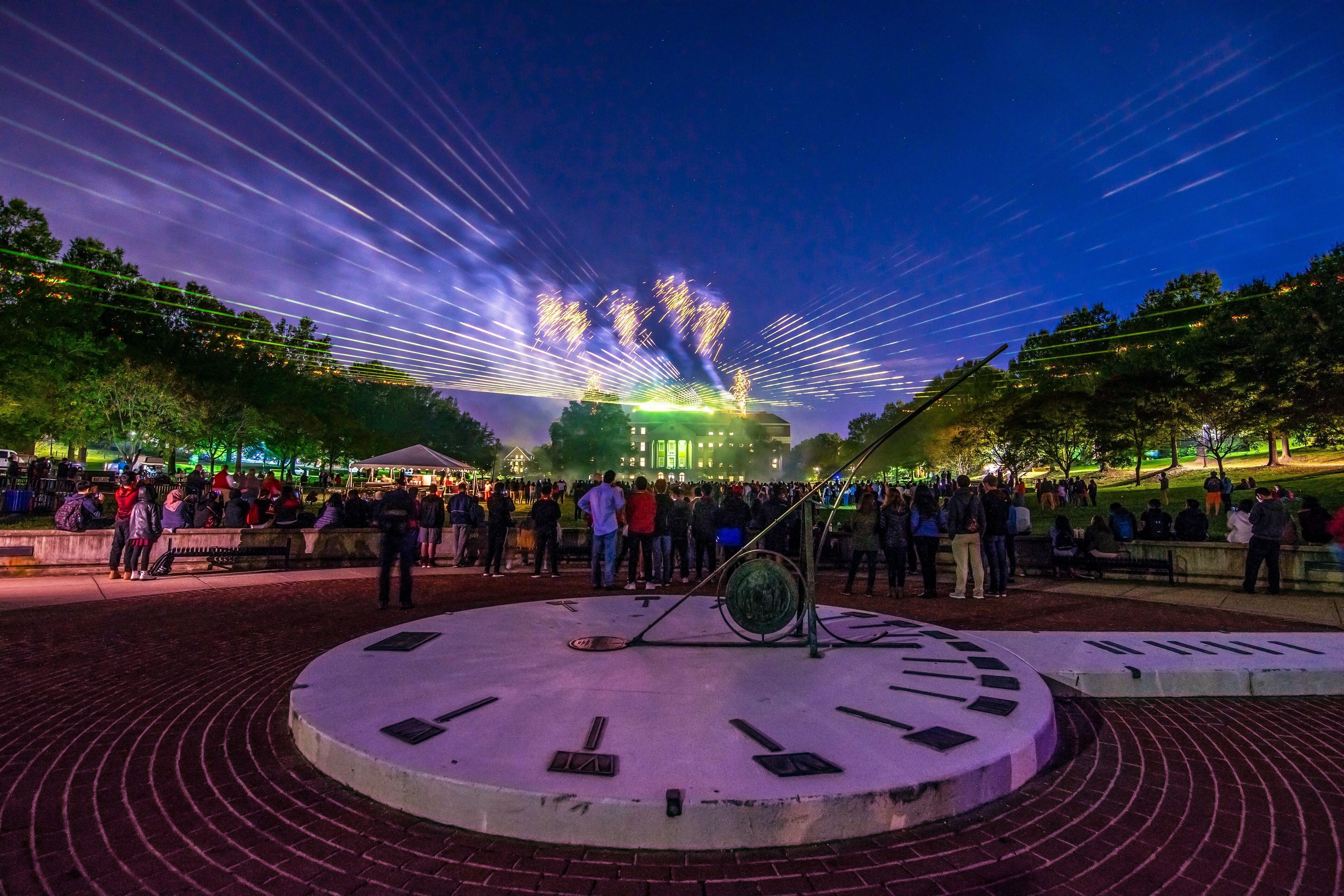 students standing by the sun dial on McKeldin mall