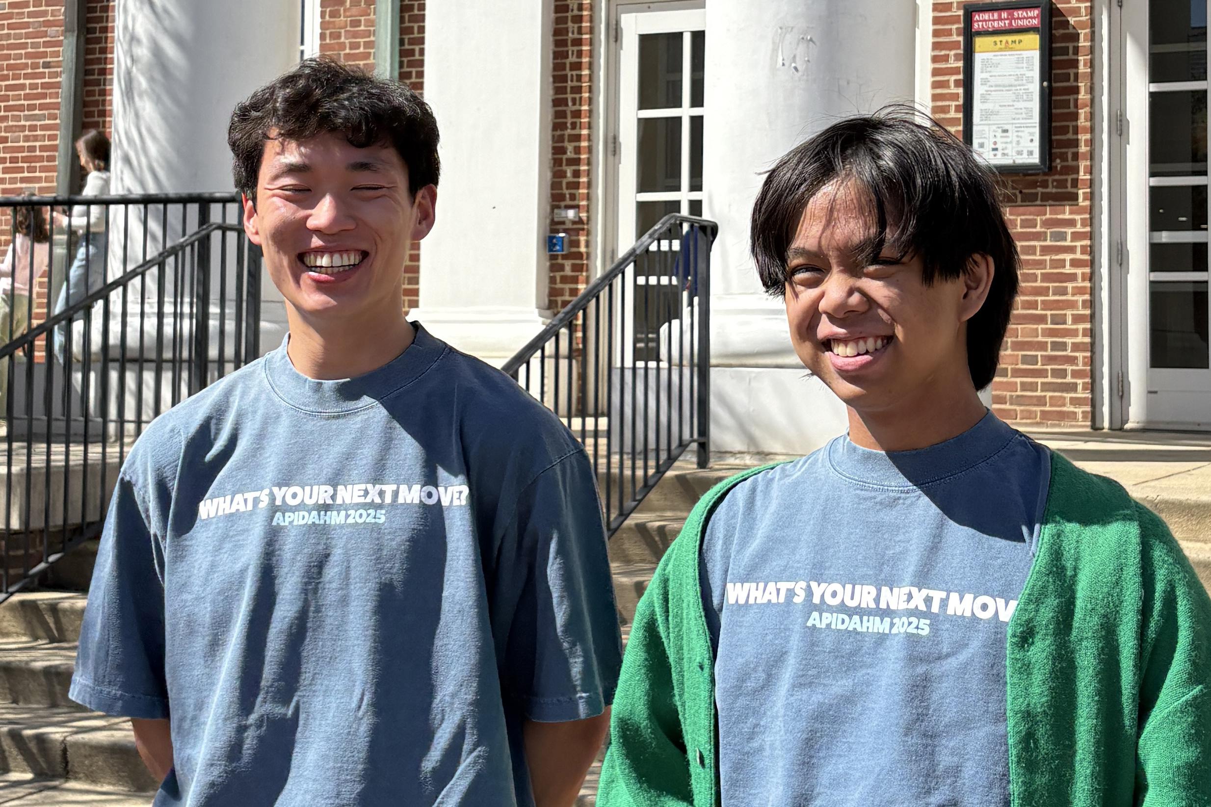 two students standing outside Stamp