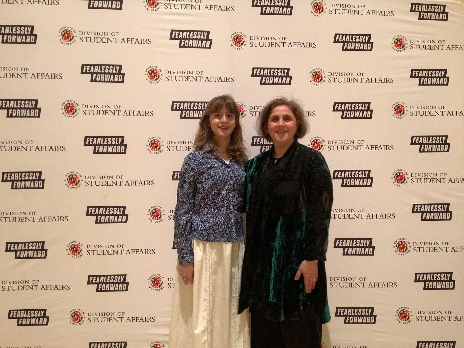 A photobooth photo of an award recipient and her guest