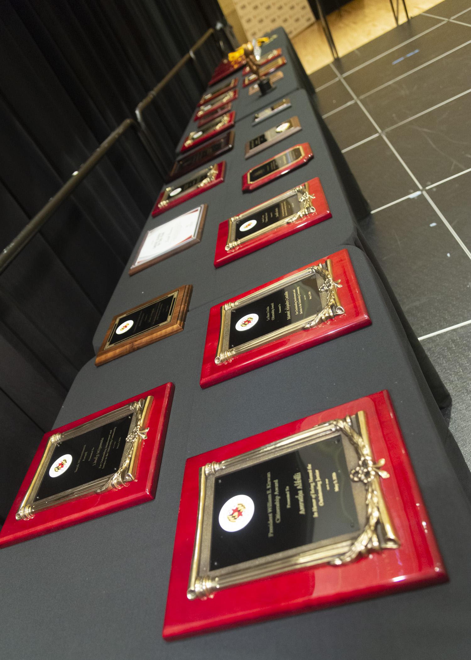 Image of the award plaques on the table behind the podium