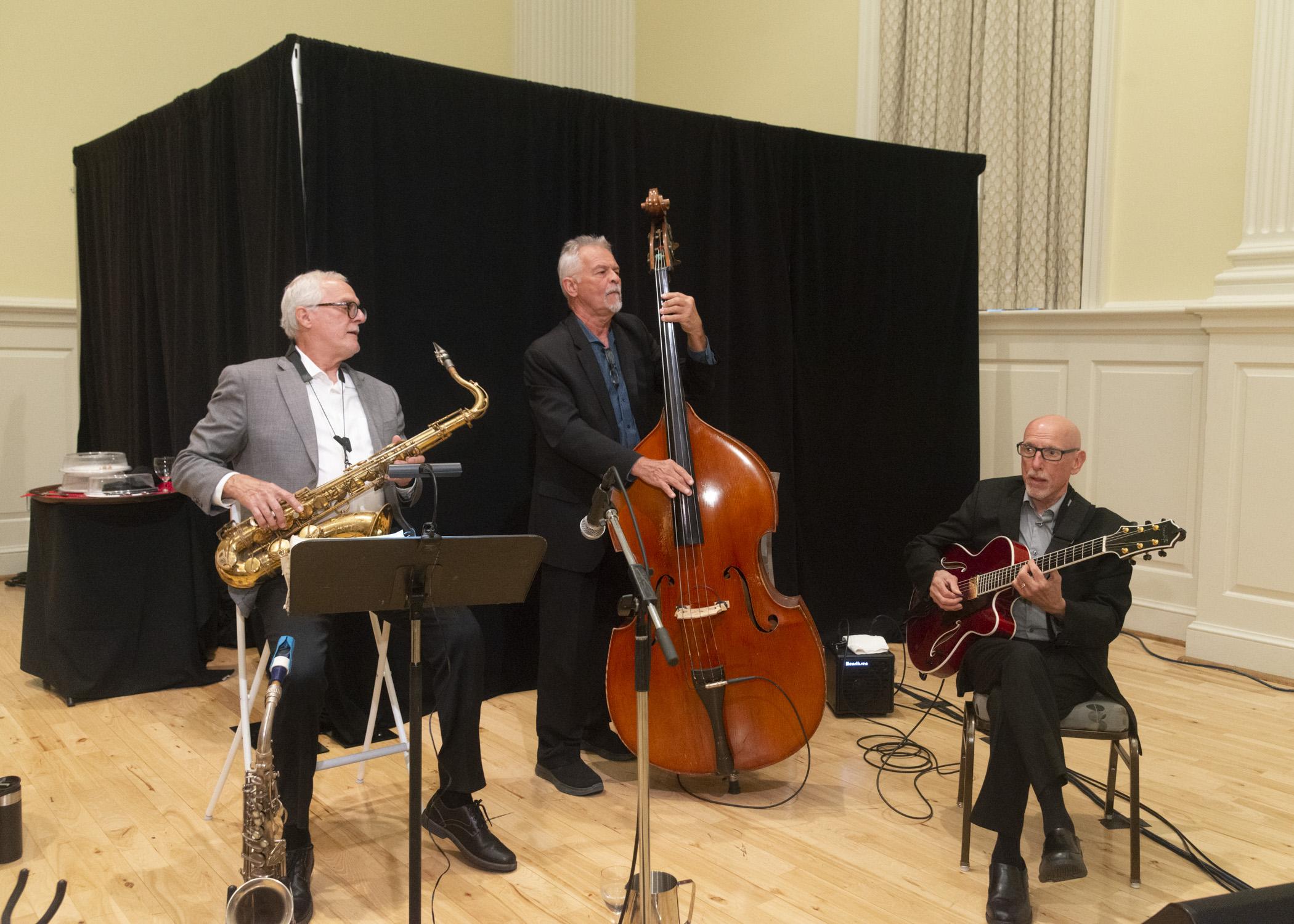 Image of the 3 member band playing a song