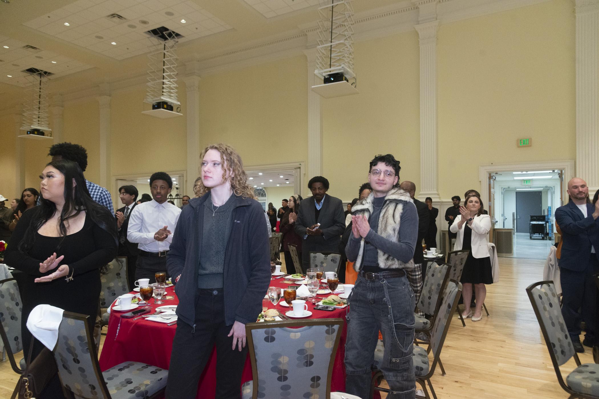 Photo of atendees standing for the UMD alma mater