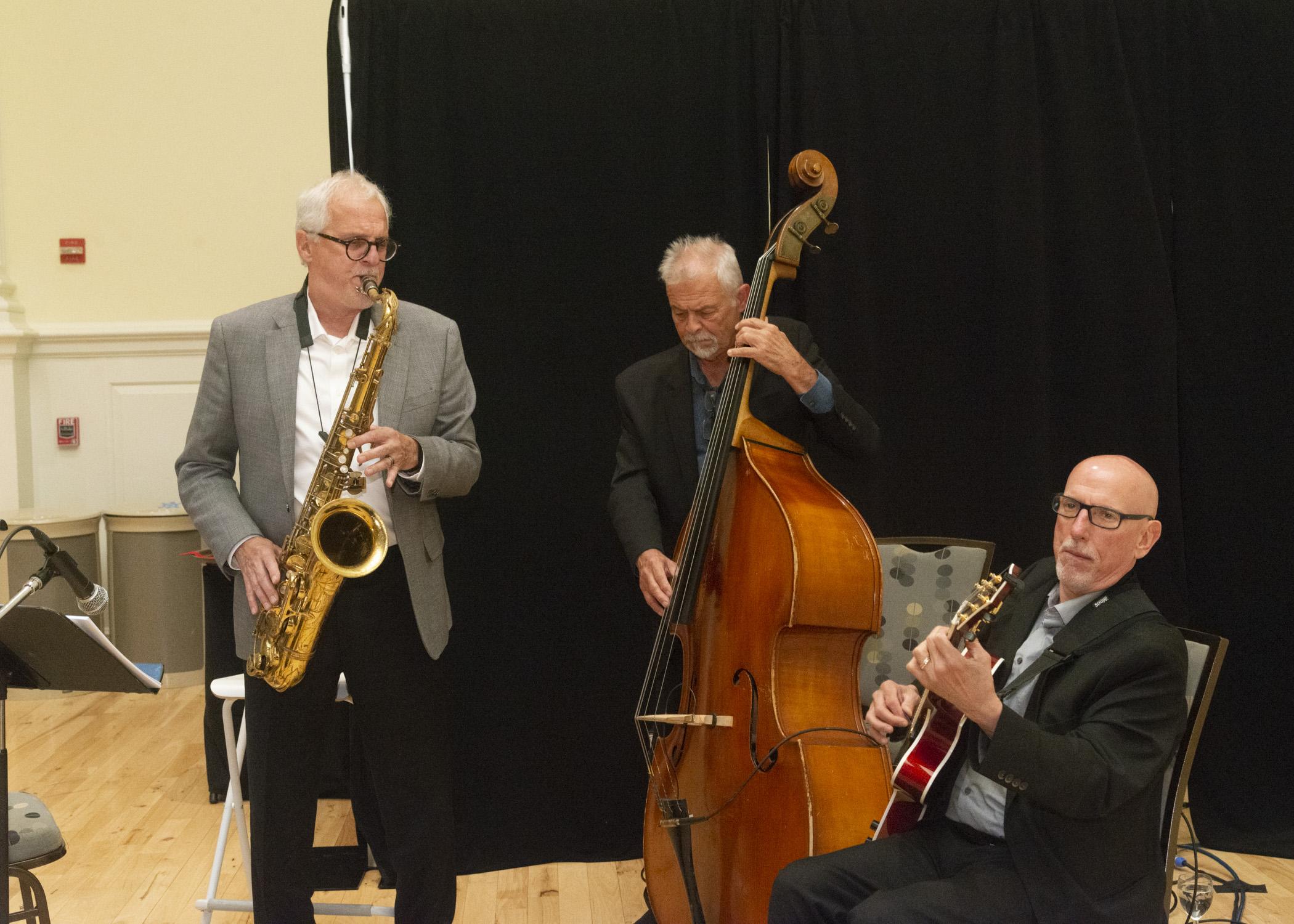 Photo of the 3 member band playing a song