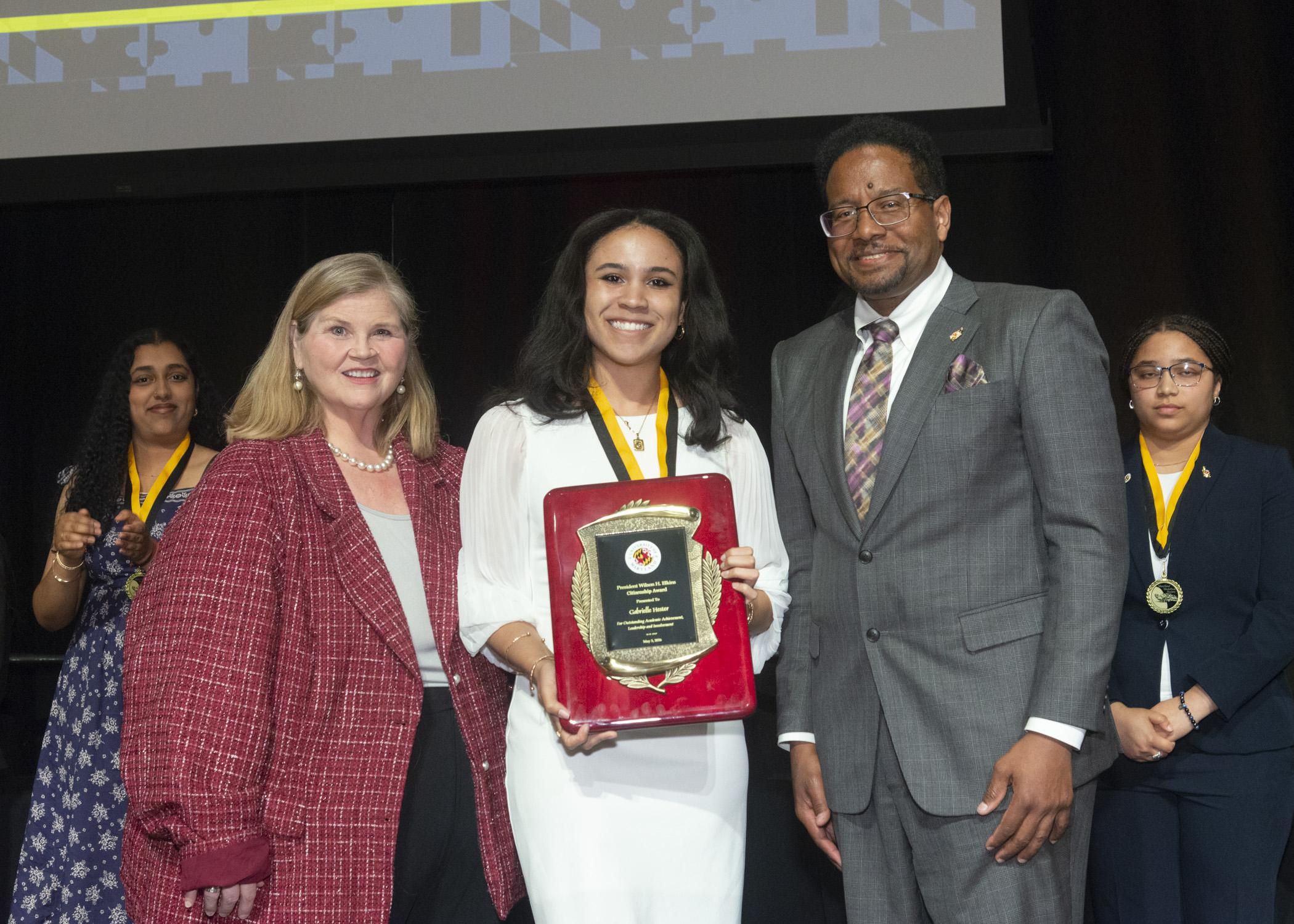 A photo of Dr. Patty Perillo, Gabrielle Hester, the Wilson H. Elkins recipient and President Pines