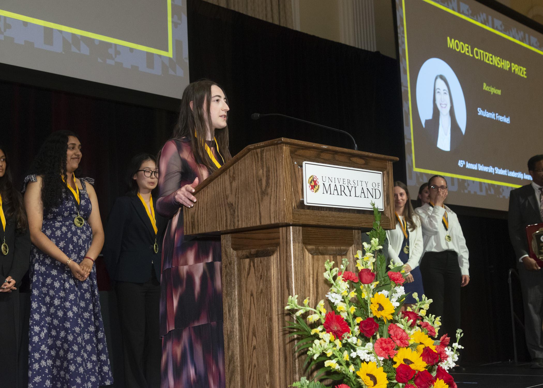 A photo of Shulamit Frenkel, the Model Citizen prize recipient, giving a speech
