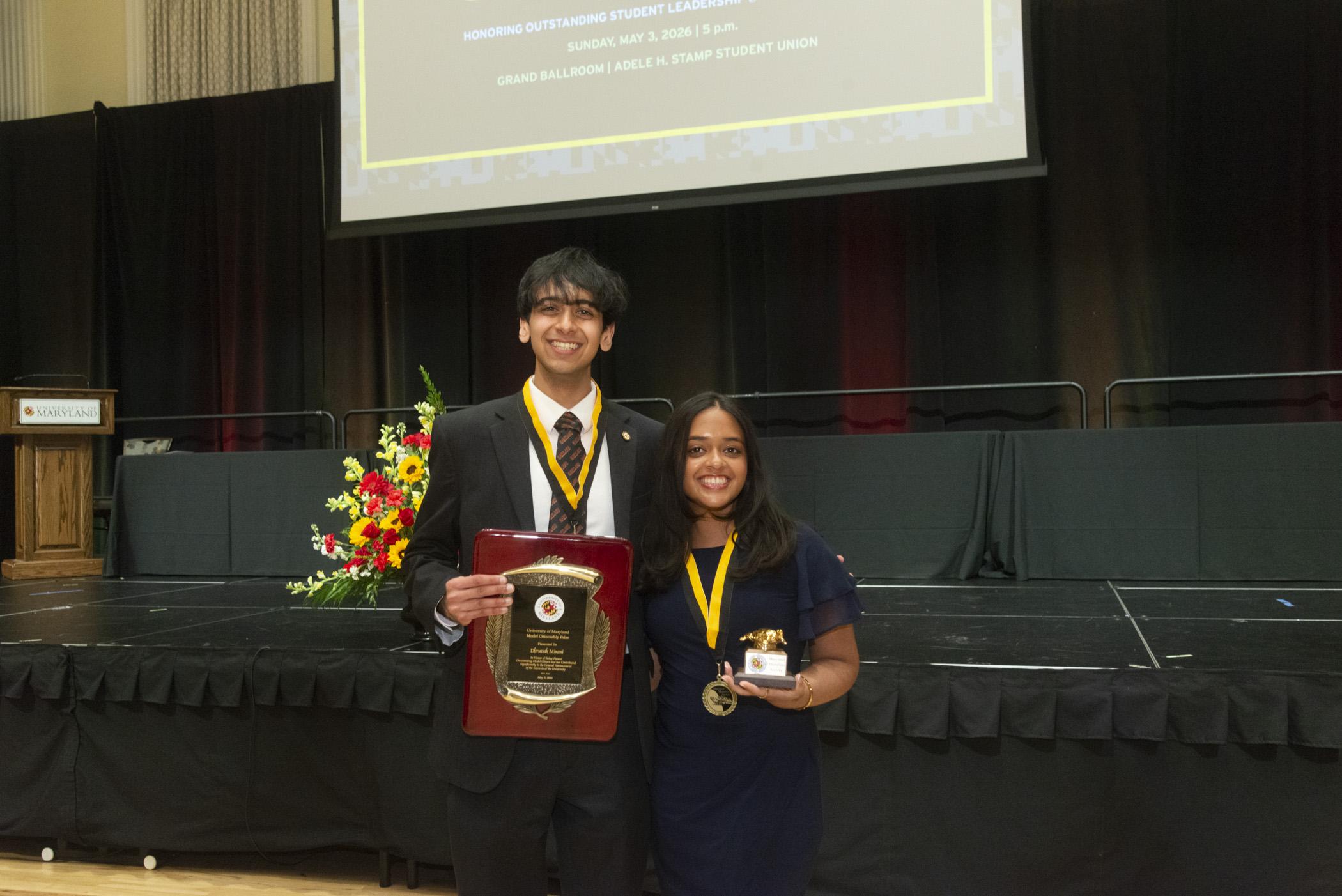 A photo of two of the 2026 award recipients holdng up their awards