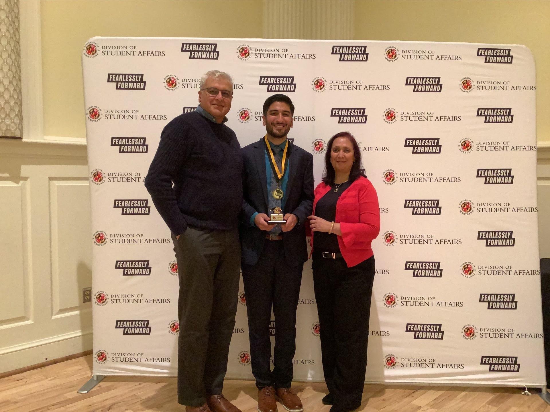 Photobooth photo of an award recipient and his family