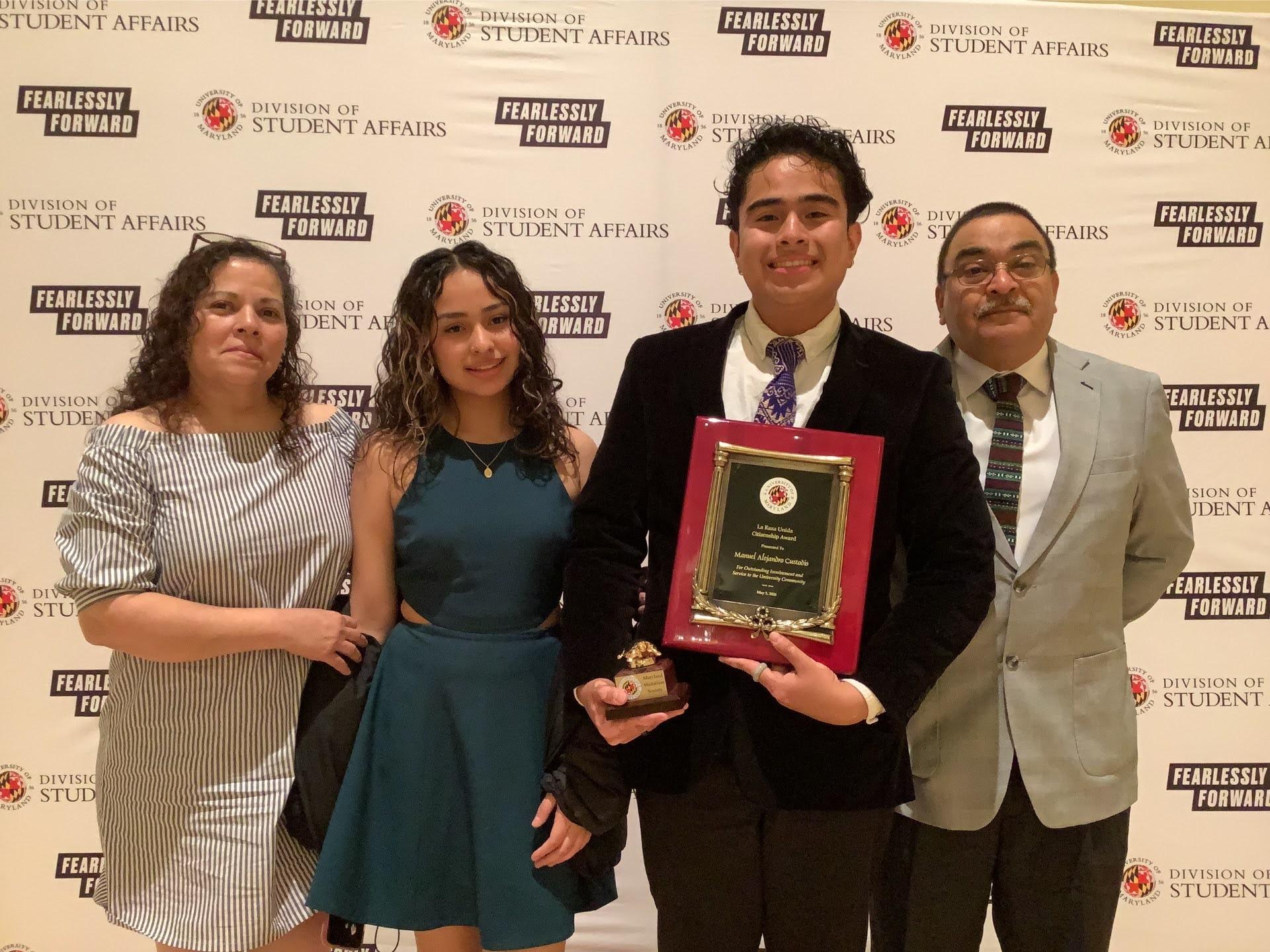Photobooth photo of an award recipient and his family