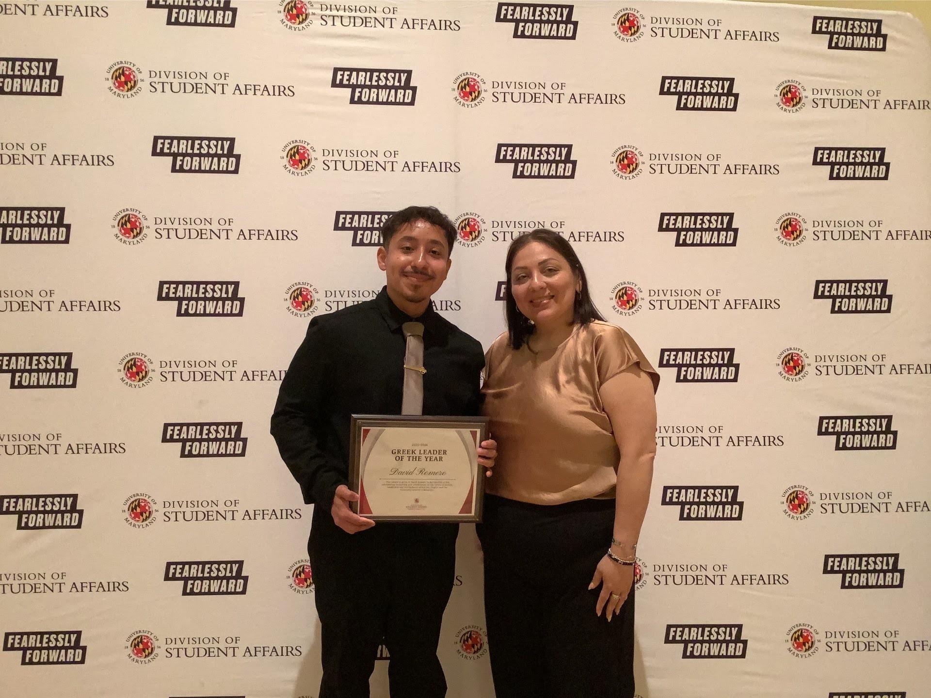 Photobooth photo of an award recipient and his guest