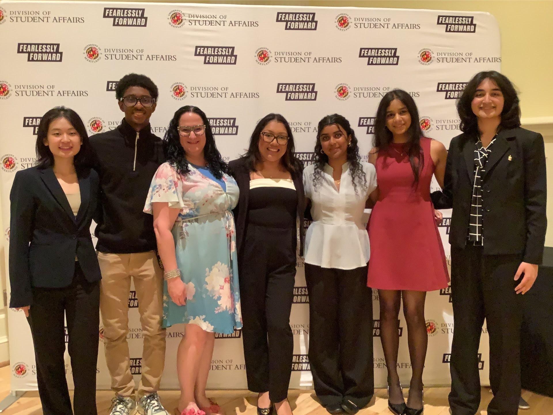 Photobooth photo of six award recipients and a staff member