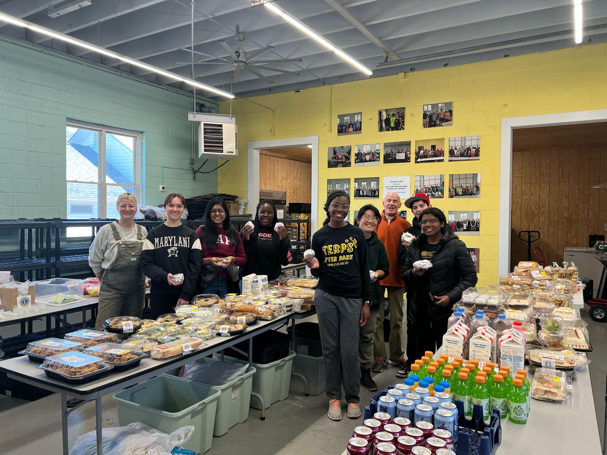The AB team in Wytheville is taking a photo with the food they are going to package up for the community. 