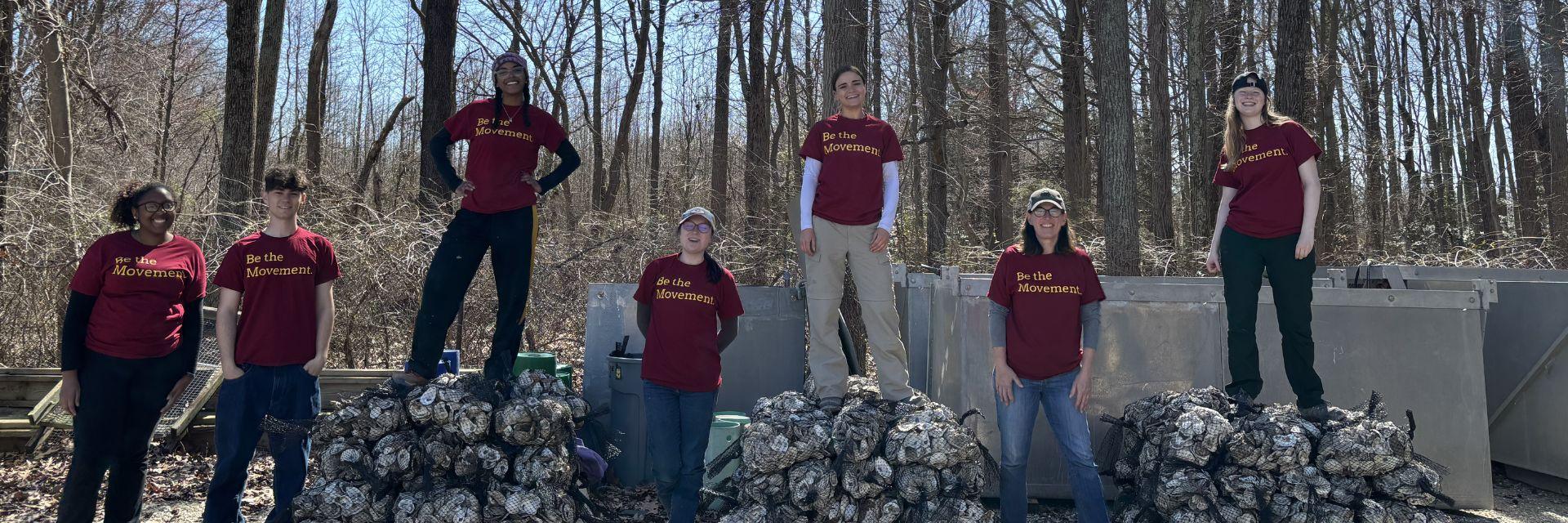AB Team in Annapolis poses on top of the oysters they restored. 