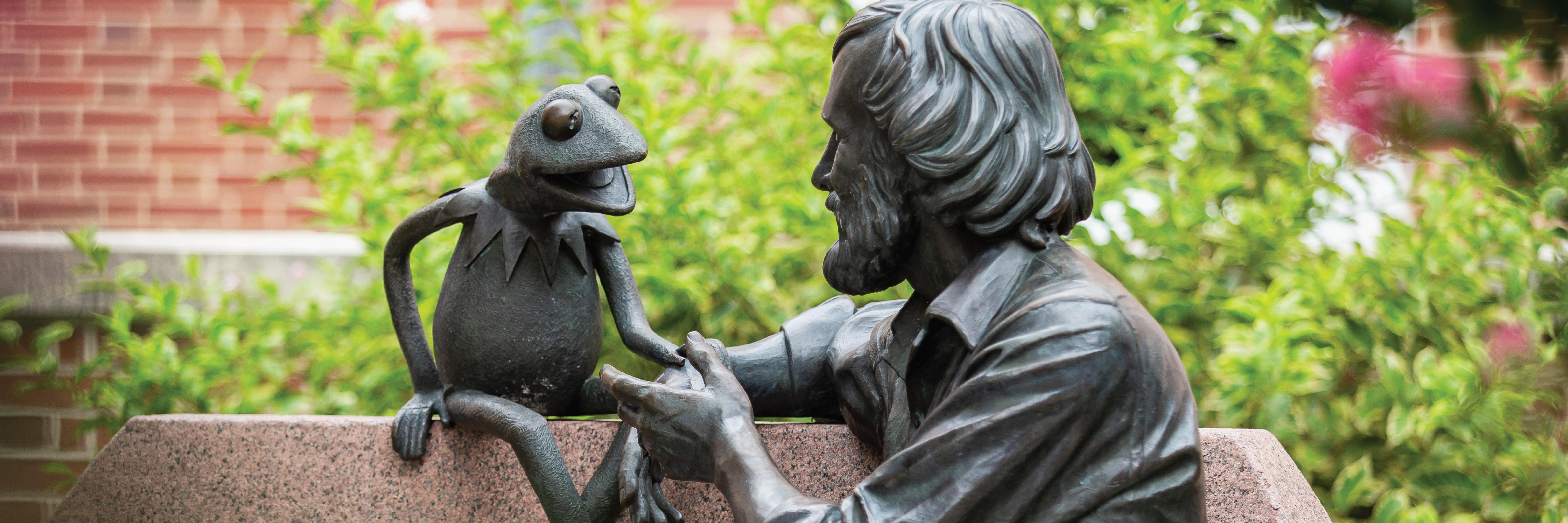 Photo of the Jim Henson Memorial Statue in front of The Adele H. Stamp Student Union—Center for Campus Life 