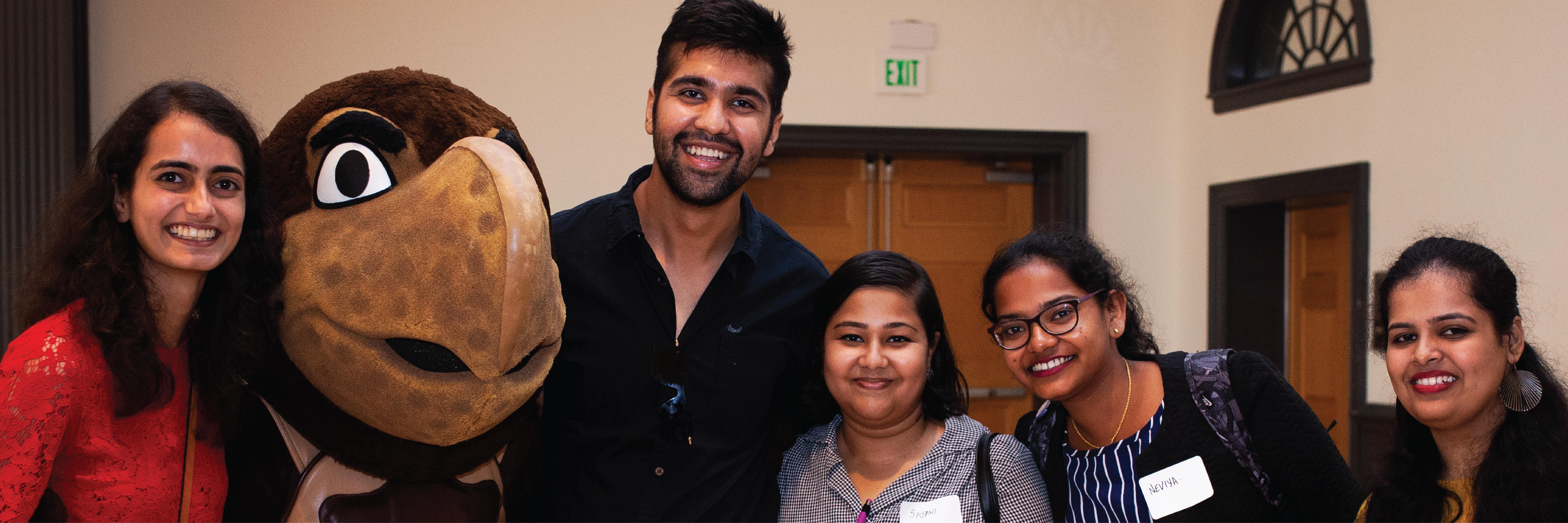 A group of graduate students posing with the UMD Testudo mascot