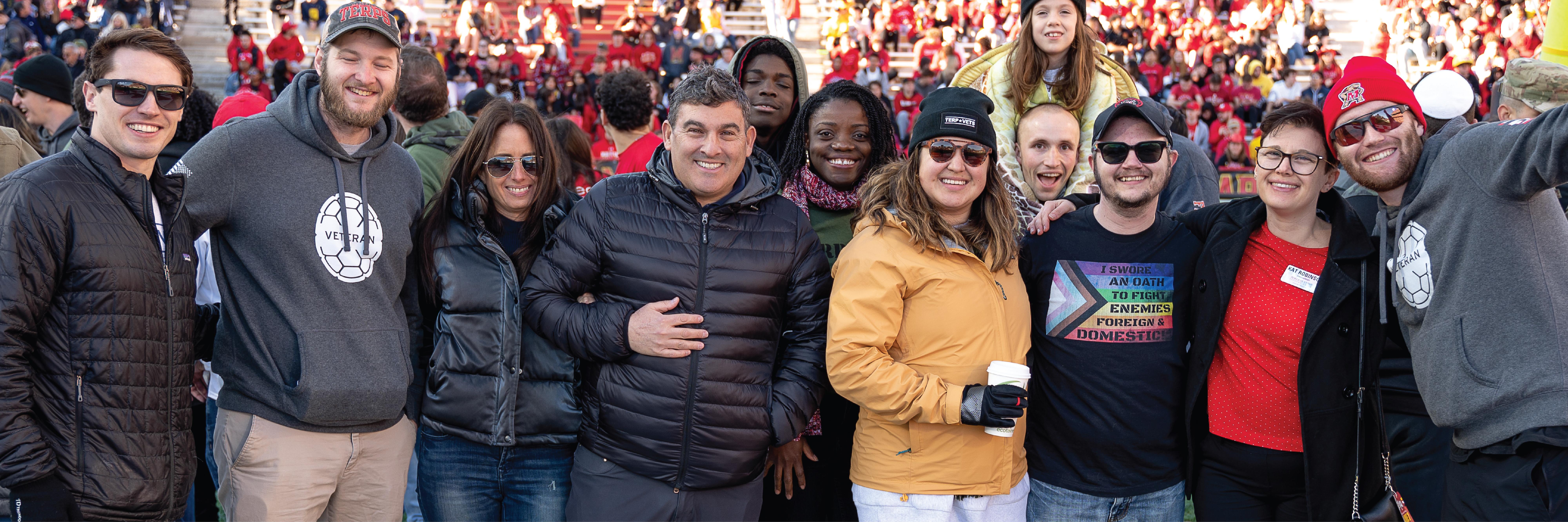 A group of University of Maryland Veterans smile at a Terps football game