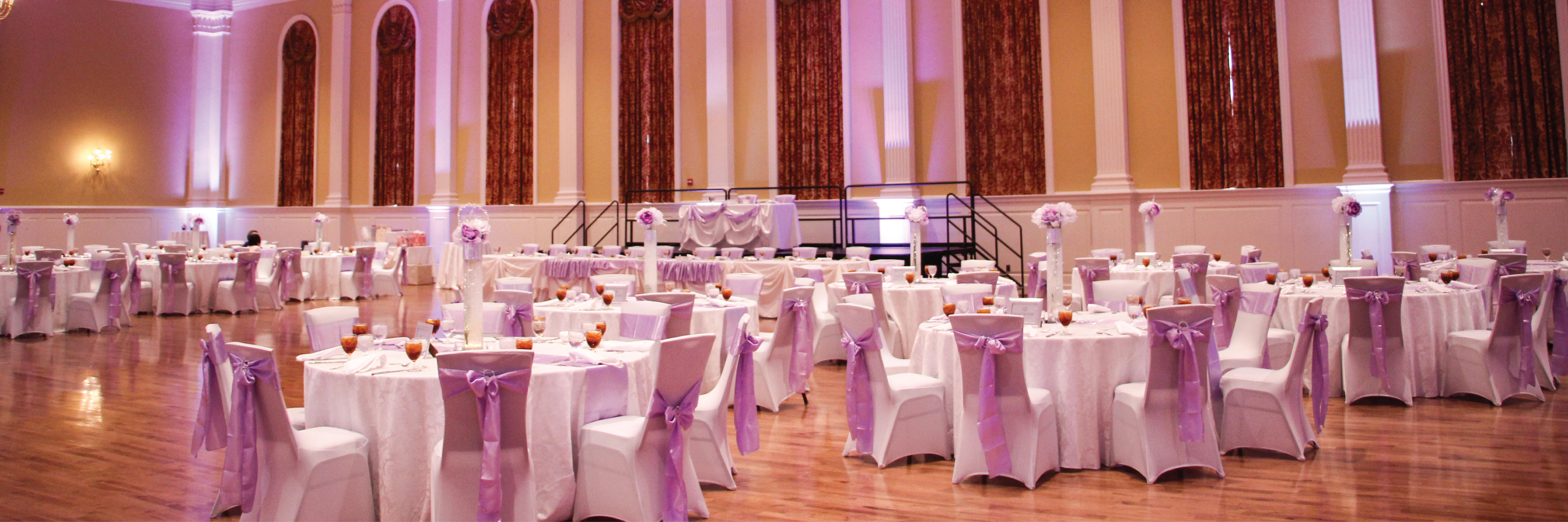 Round tables and chairs set up in the STAMP Grand Ballroom for a wedding reception